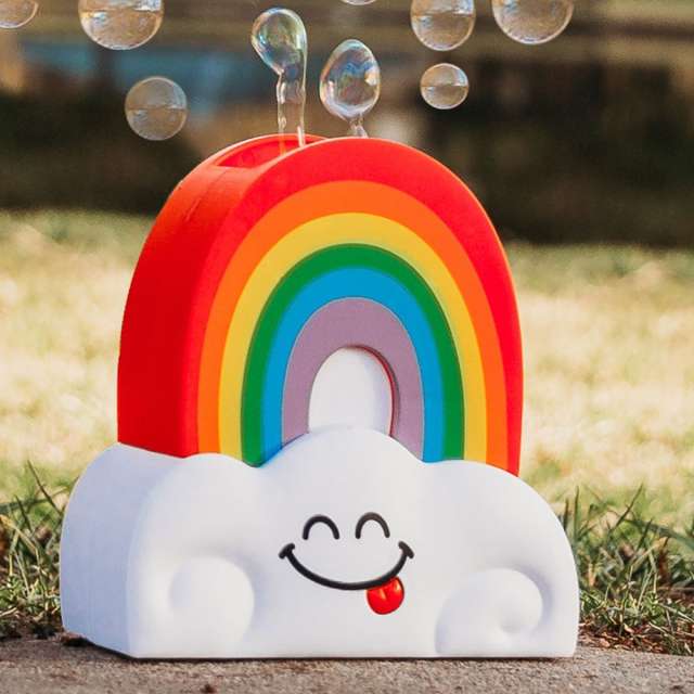 Plastic rainbow sitting on a cloud with bubbles coming out the top.